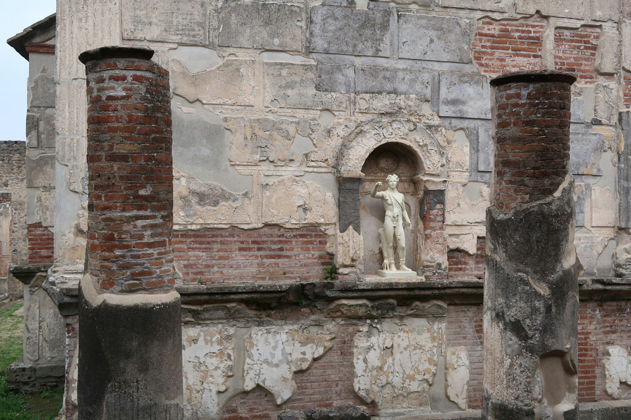 a statue of a woman on a wall of a building